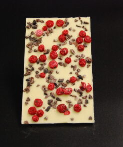 Tafel aus weißer Schokolade bestreut mit Kakaonibs und getrockneten Johannisbeeren
